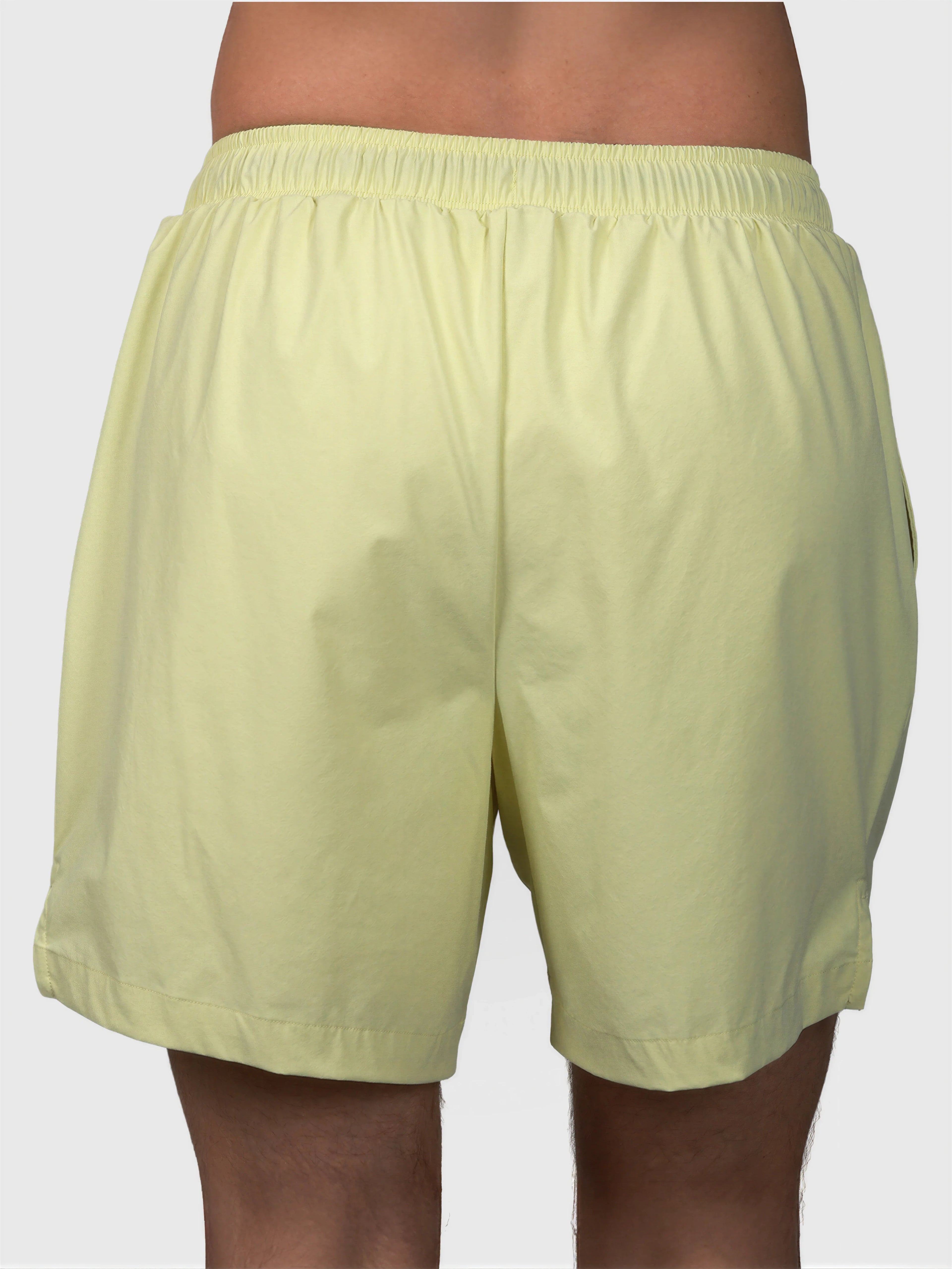 Back view of citron Apex Pro Compression Short by MUEV designed for padel and pickleball clothing