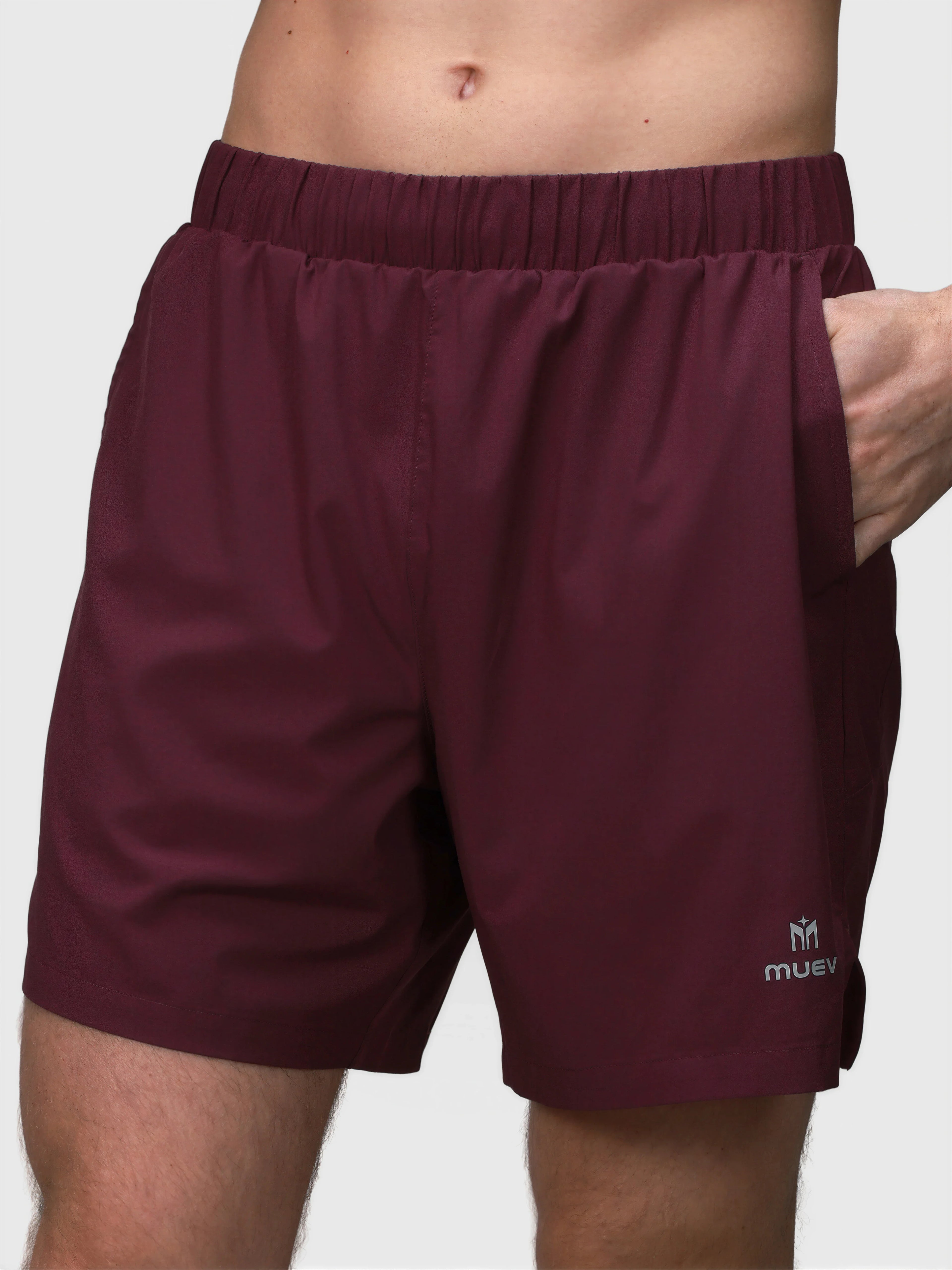 Front view of plum Base Line Short by MUEV with elastic waistband and side pockets for padel and pickleball apparel