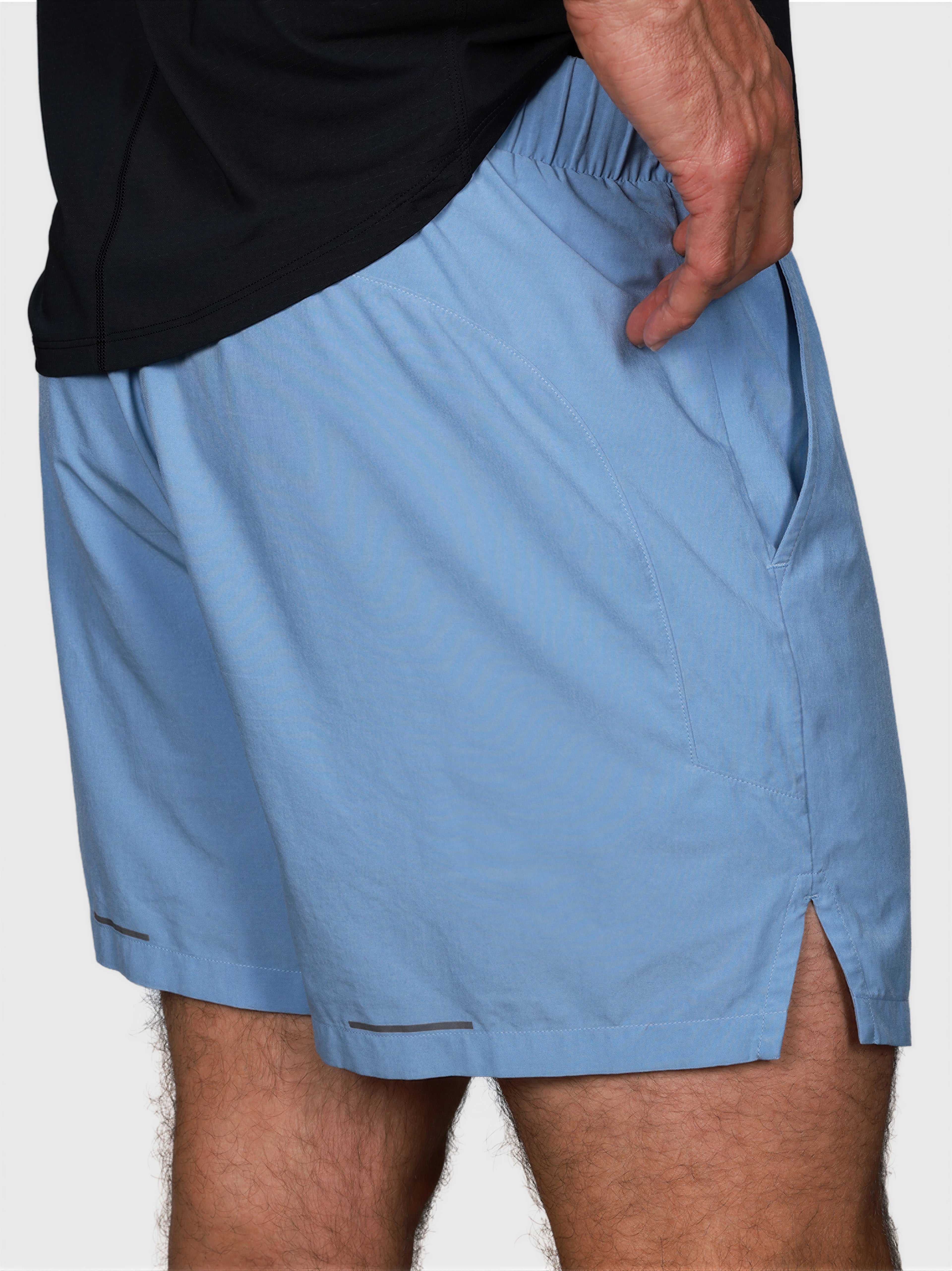 side view of man wearing Cloud Blue Base Line Short by MUEV designed for padel and pickleball apparel