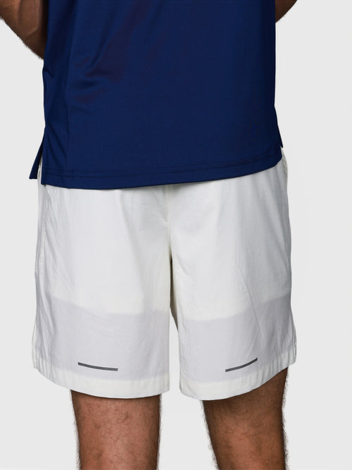 back view of man wearing white Base Line Short by MUEV designed for pickleball and padel apparel