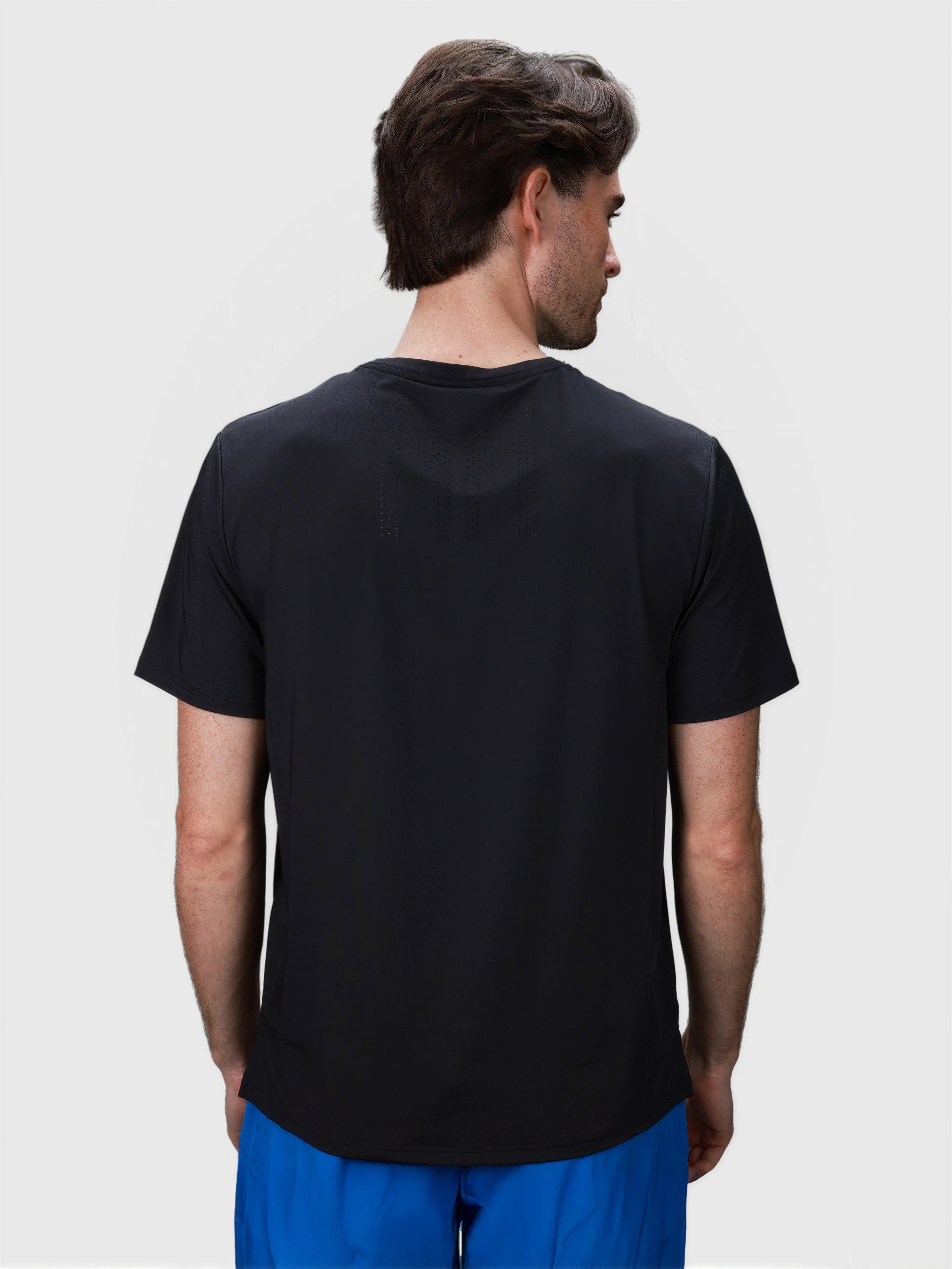 Rear view of black Chevron Tee by MUEV designed for padel and pickleball apparel with breathable fabric details